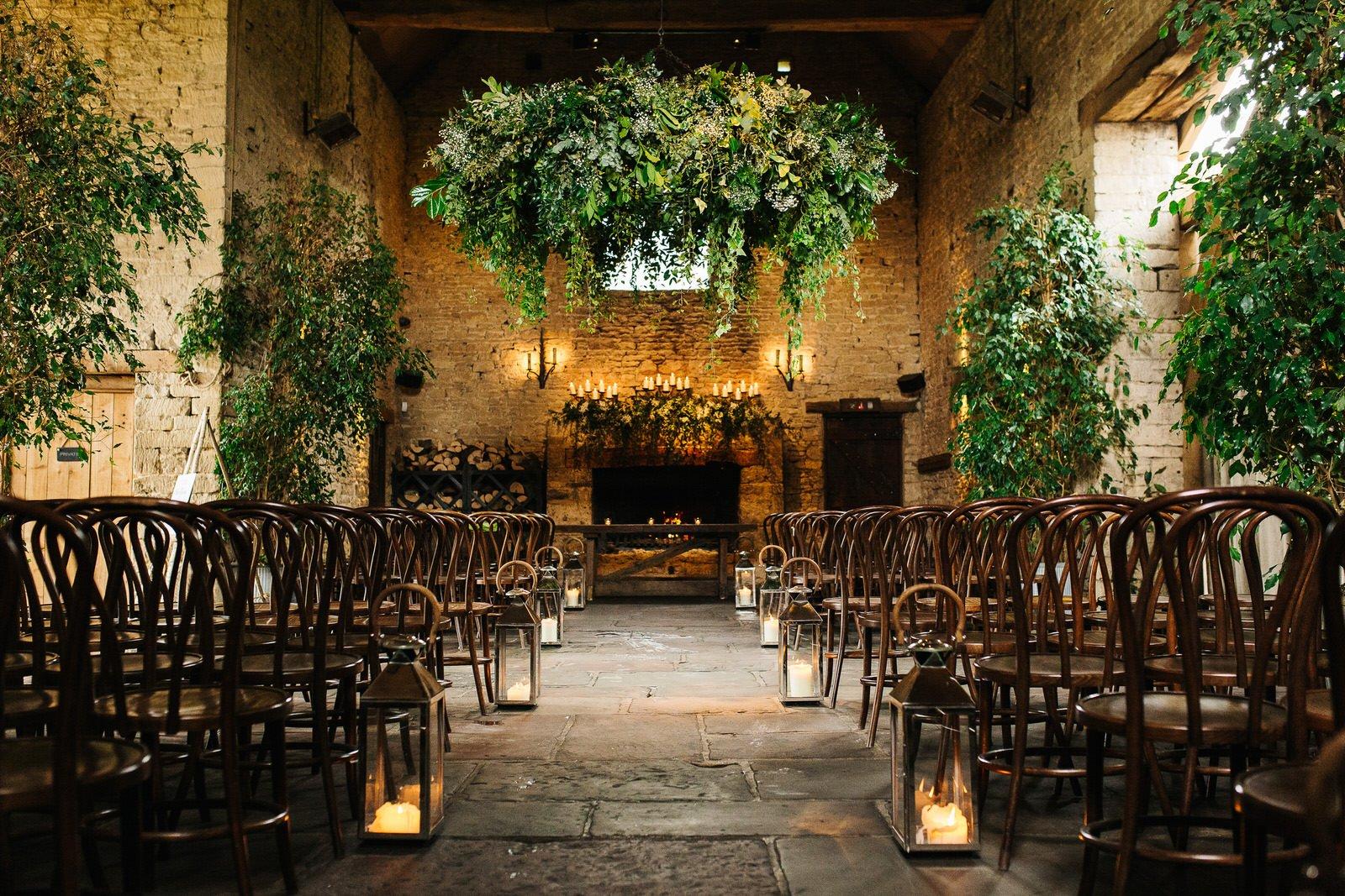 Candlelit wedding aisle with green plants