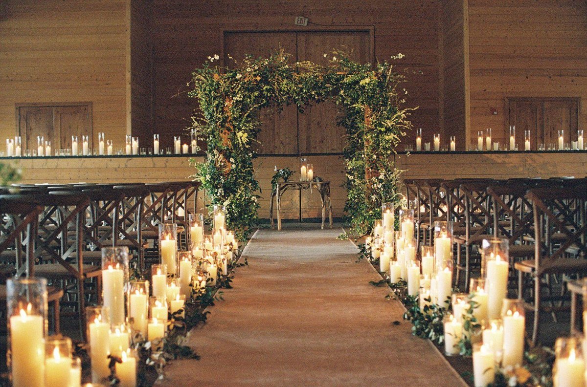 Candlelit indoor winter wedding aisle