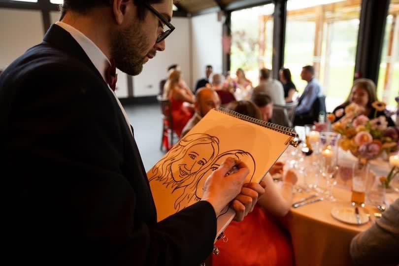 Caricature artist drawing wedding guests