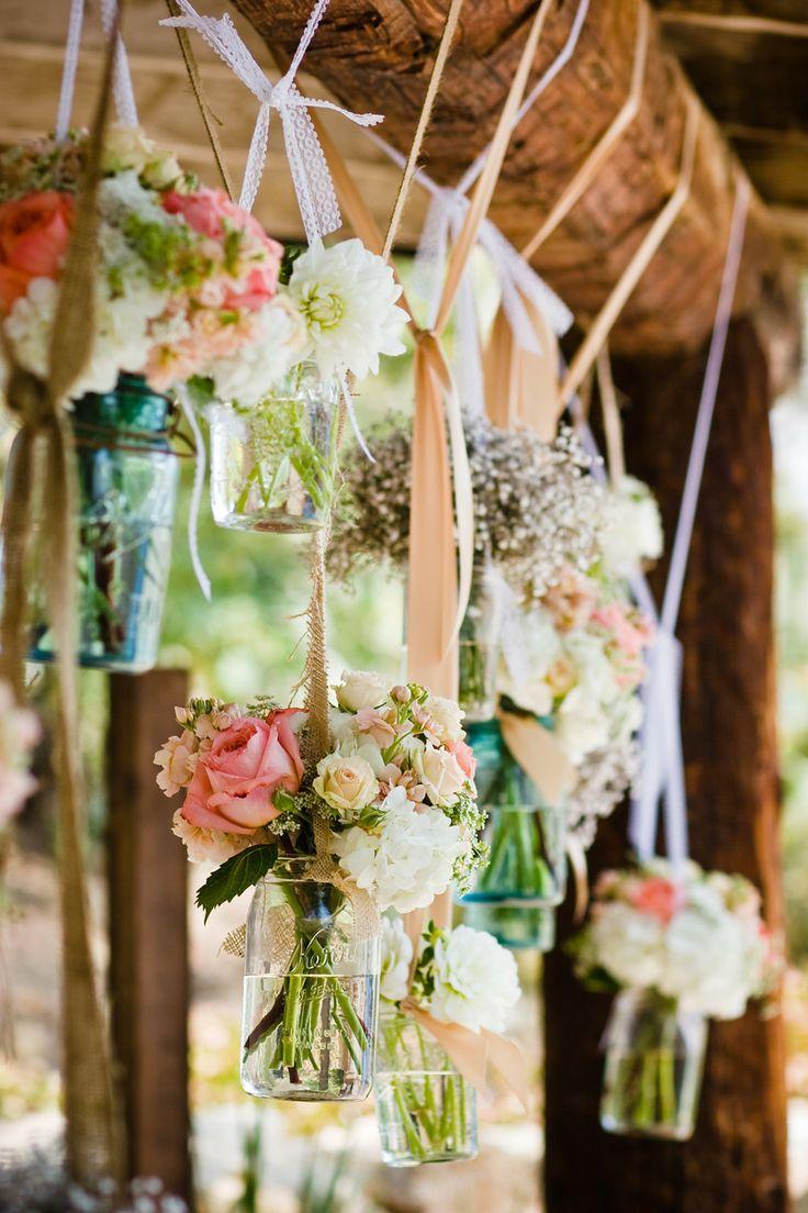 Floral mason jars hanging at wedding