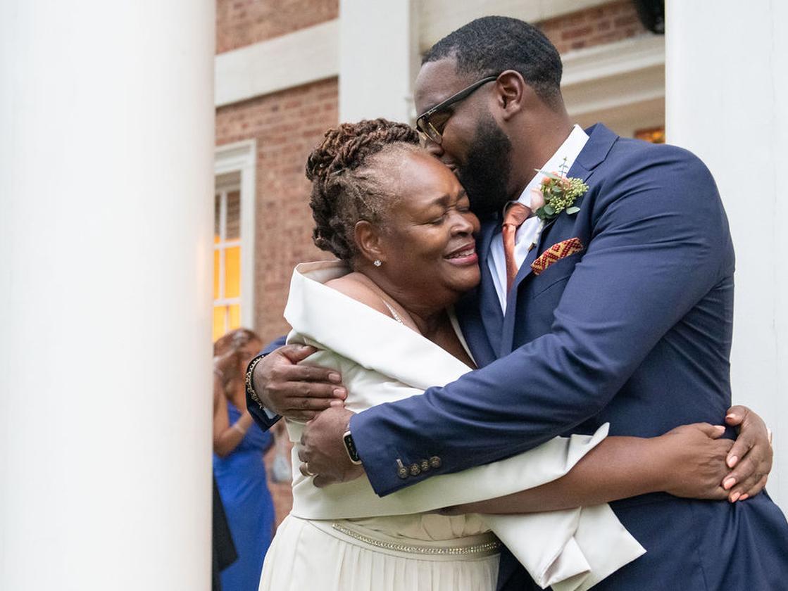 groom hugging mother on wedding day