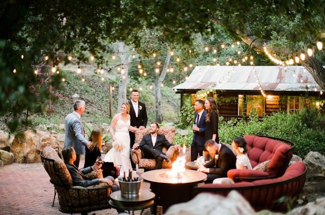 Fire pit lounge with rustic wedding lighting