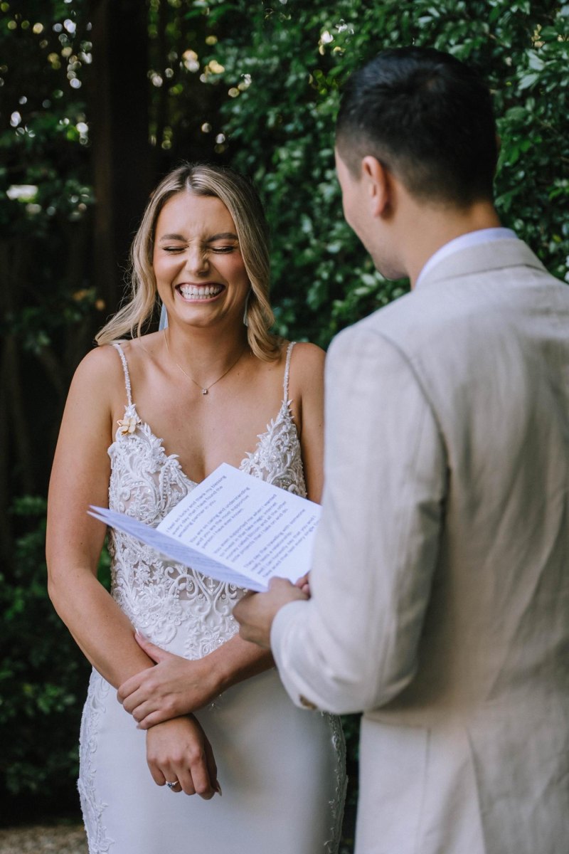 Bride laughing during vow exchange