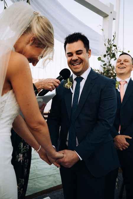Groom smiling during wedding vows