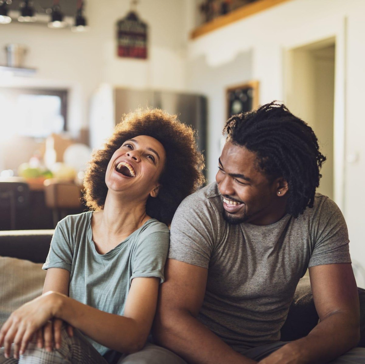 Couple laughing together at home