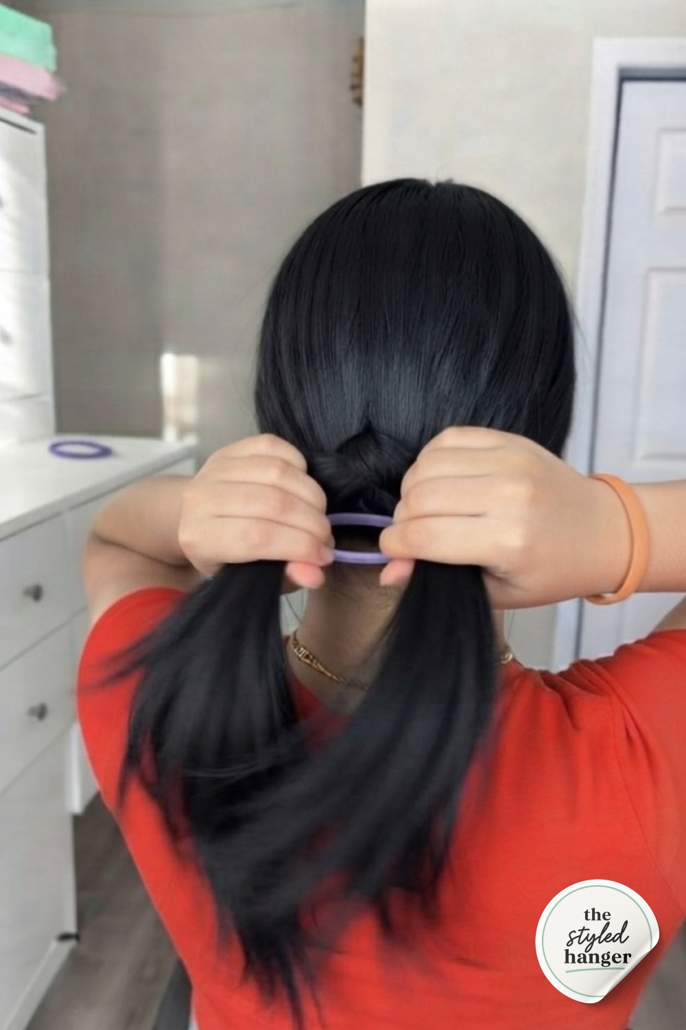 Tucking the ponytail ends through the gap mid-motion during the hair tie ponytail hack
