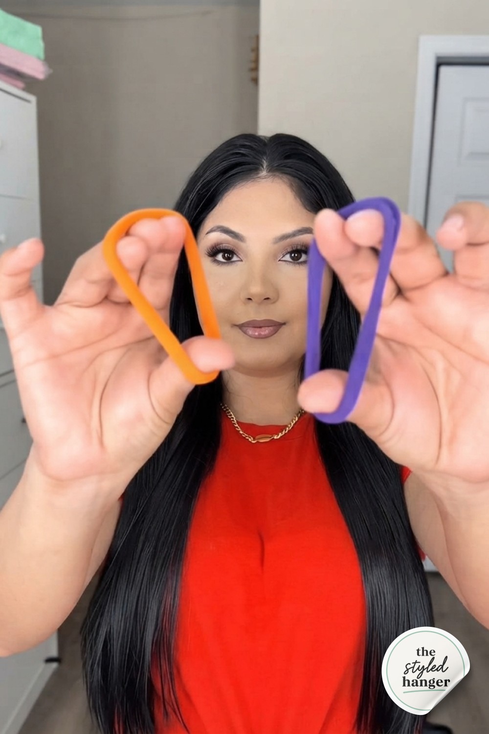 Two contrasting hair ties held up before starting the hair tie ponytail hack tutorial step by step