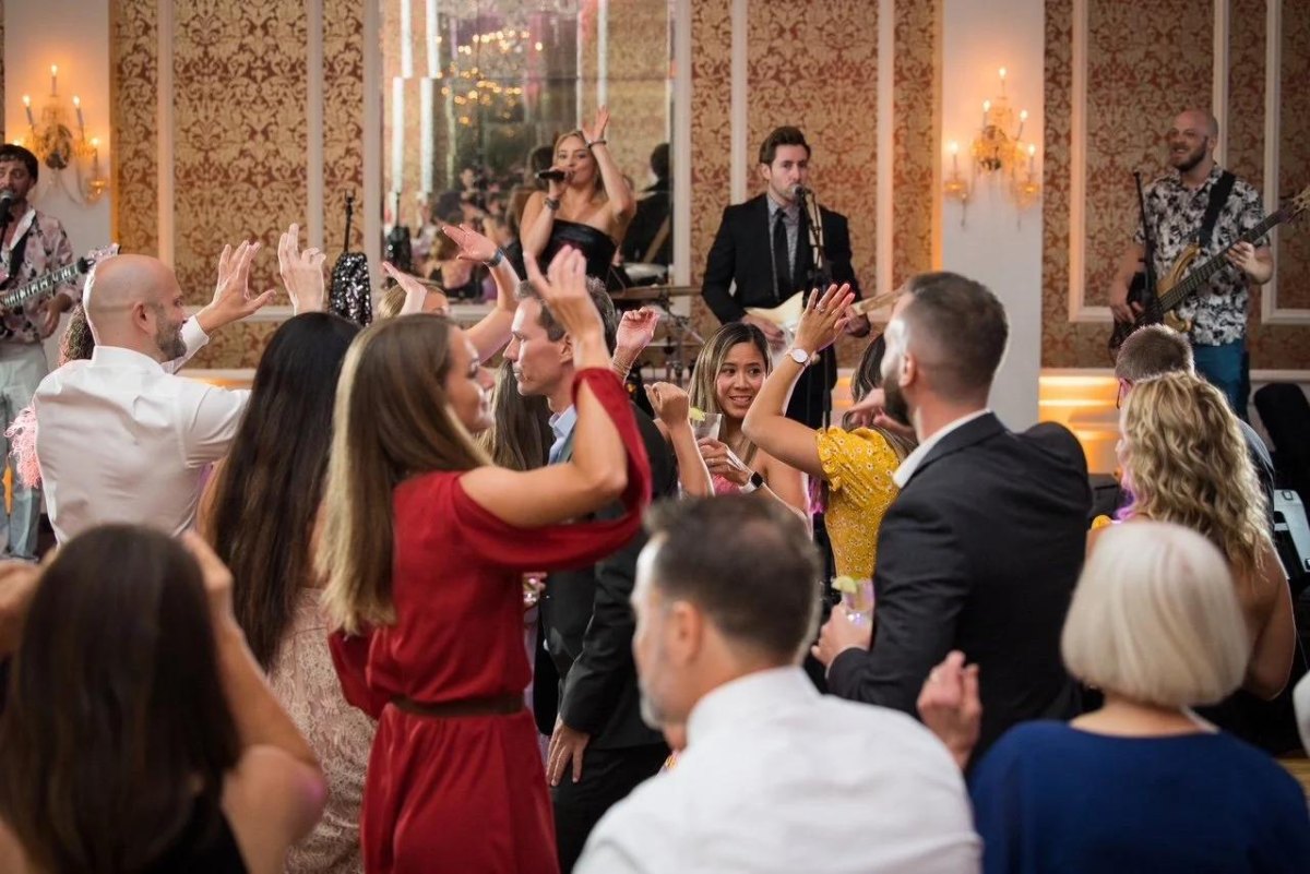 Wedding guests dancing at a live music reception