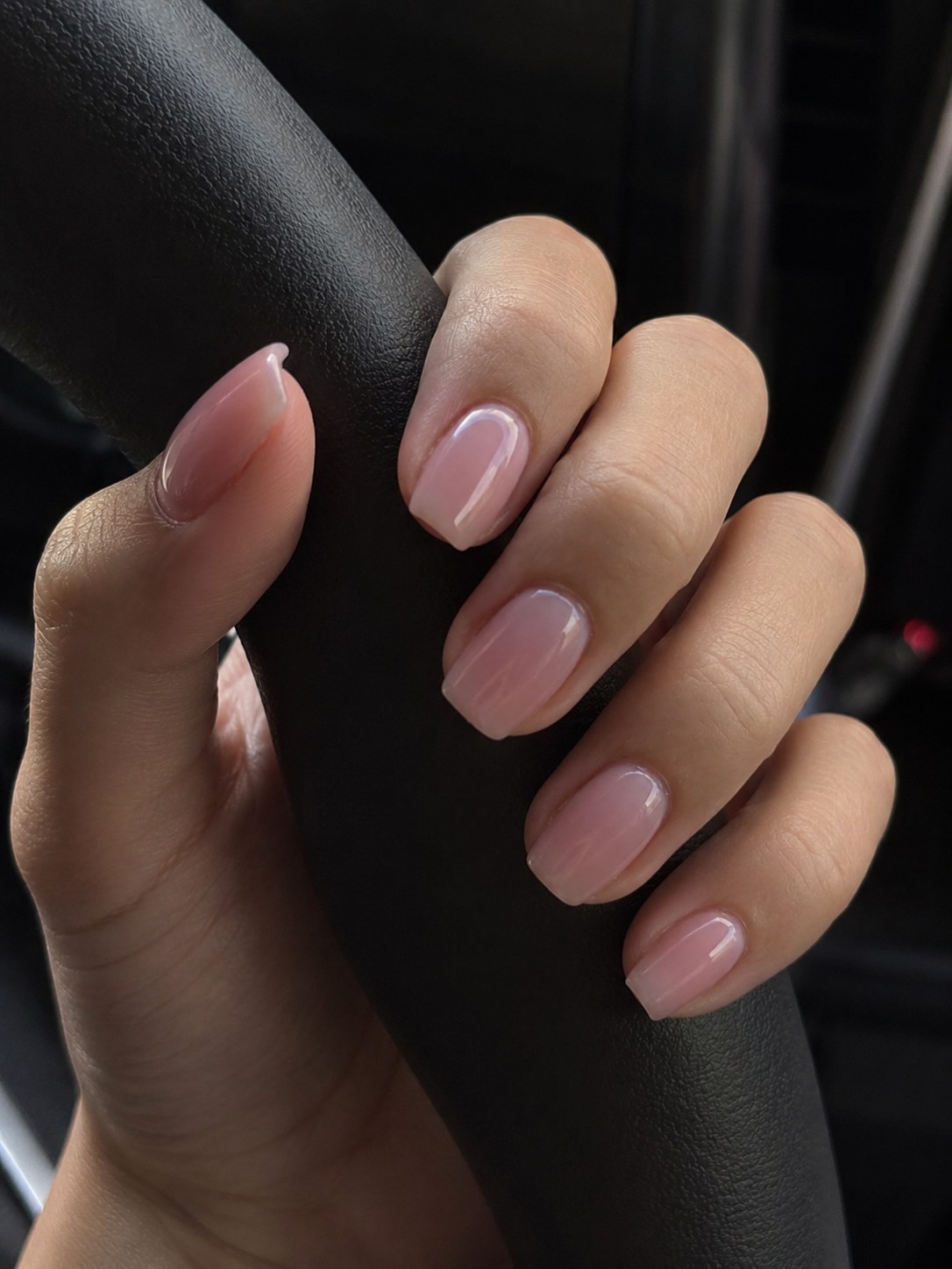 Short squoval nude-pink nails with a smooth glossy natural finish