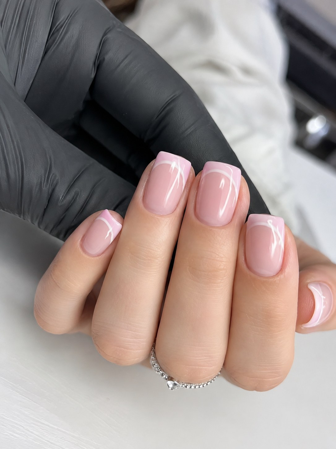 Short square nails in a milky glass pink with a subtle matching French tip