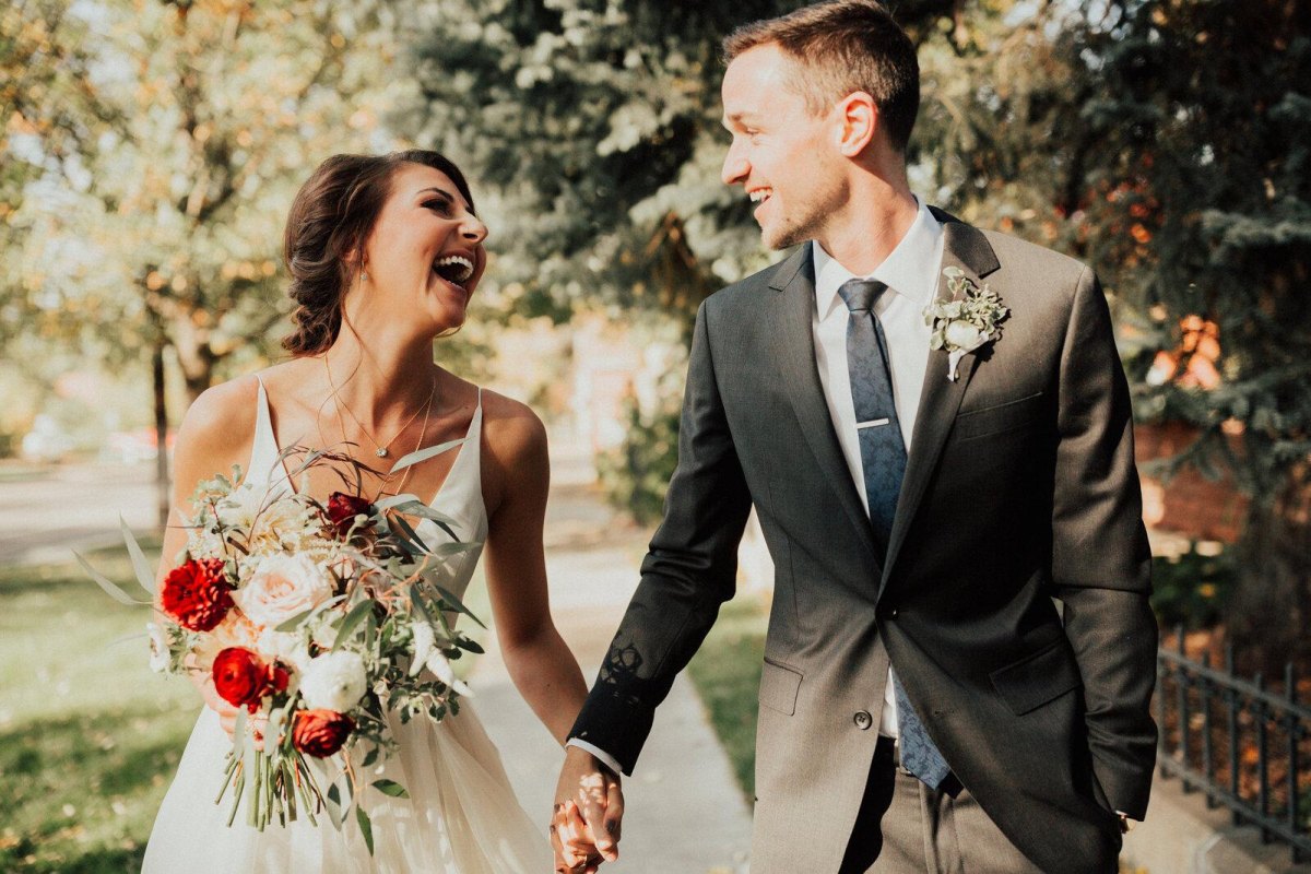 Romantic couple laughing at wedding