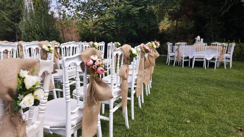 Rustic wedding chairs with floral decorations