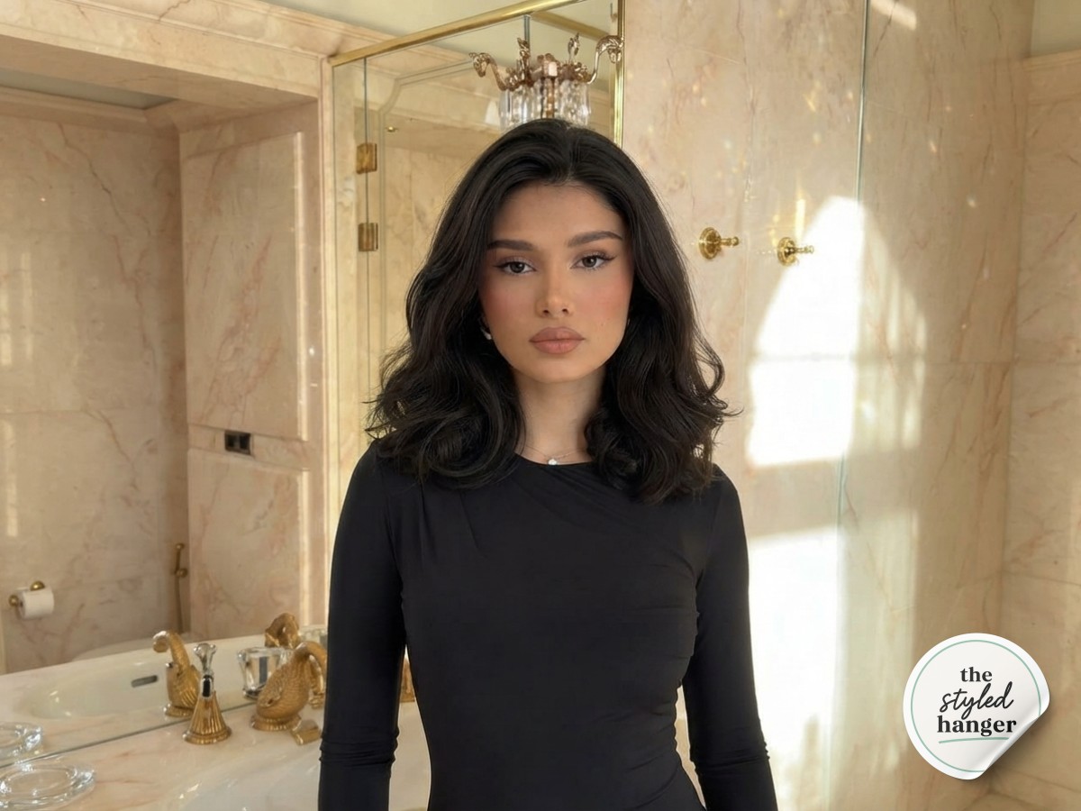 Loose shoulder-length wavy hair before starting a short hair twisted updo in a marble bathroom.