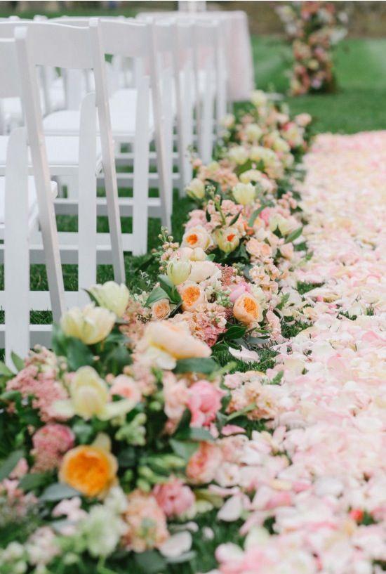 Peach flowers on garden wedding aisle