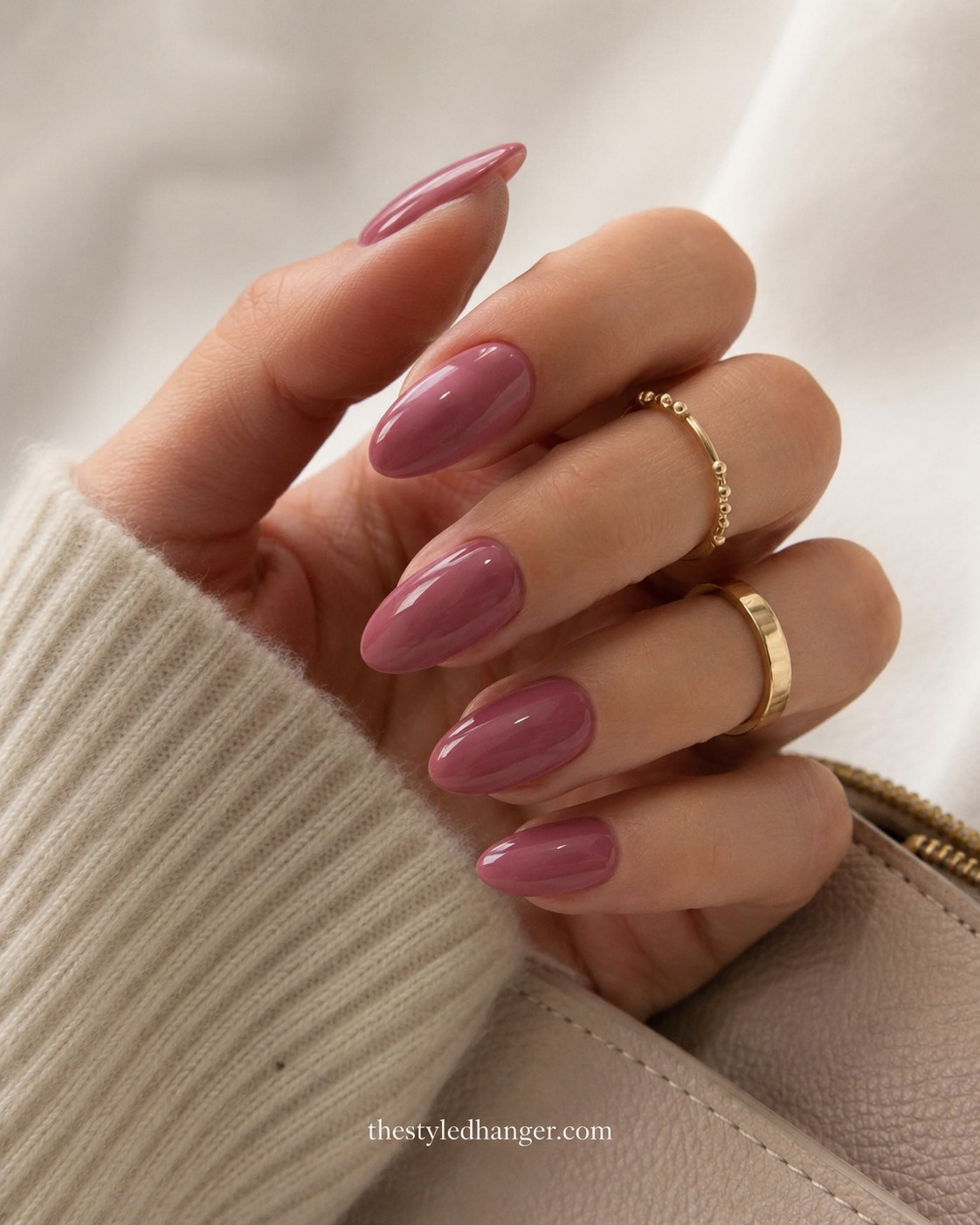 Dusty mauve nail polish on almond nails, an everyday summer nail color for dark skin