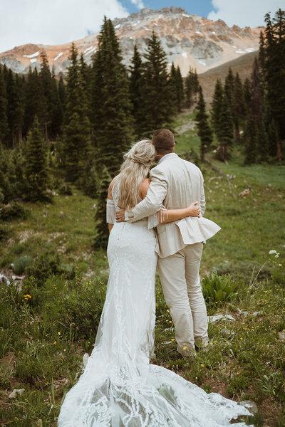Couple standing at mountain overlook elopement pose