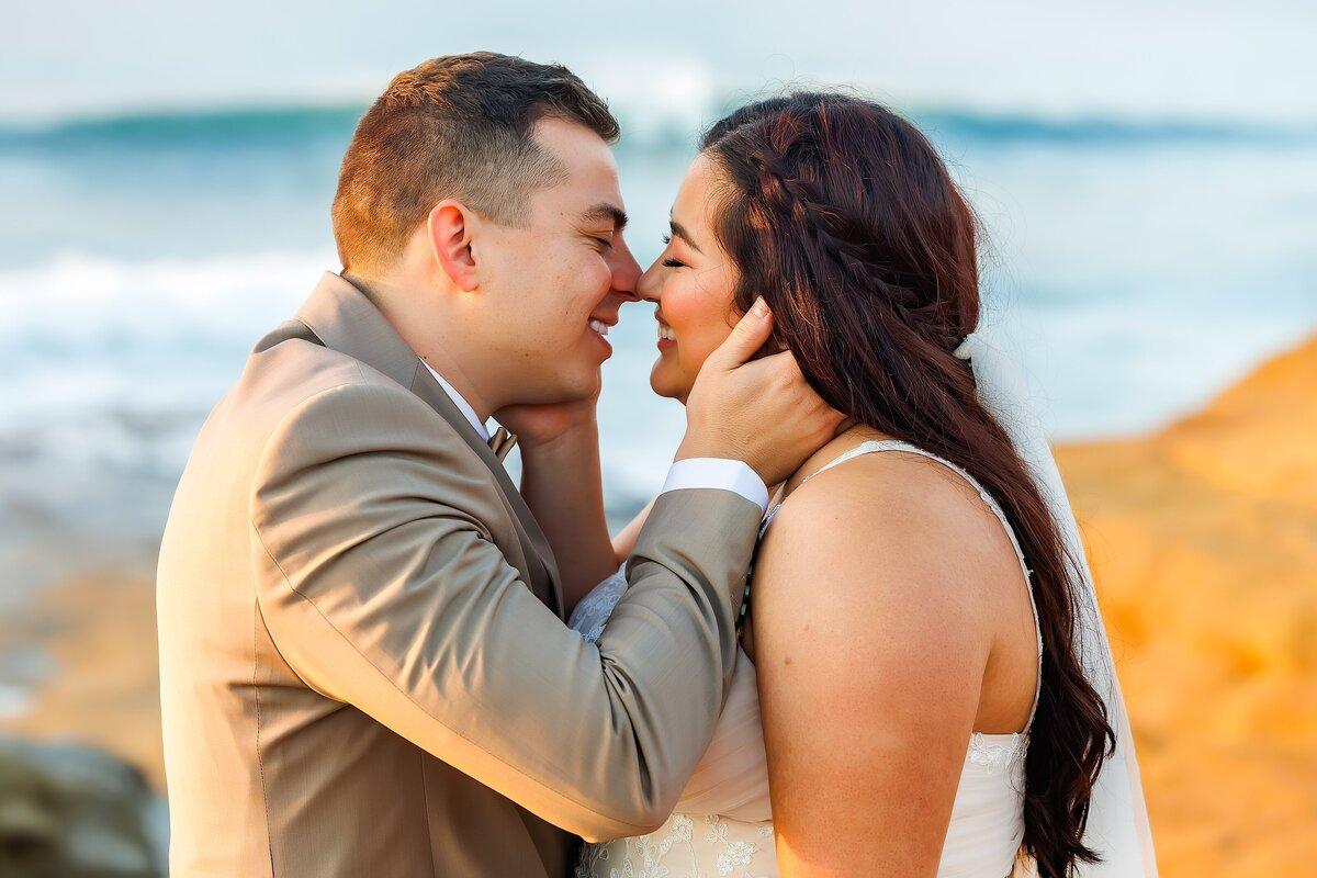 Romantic ocean kiss elopement photography pose