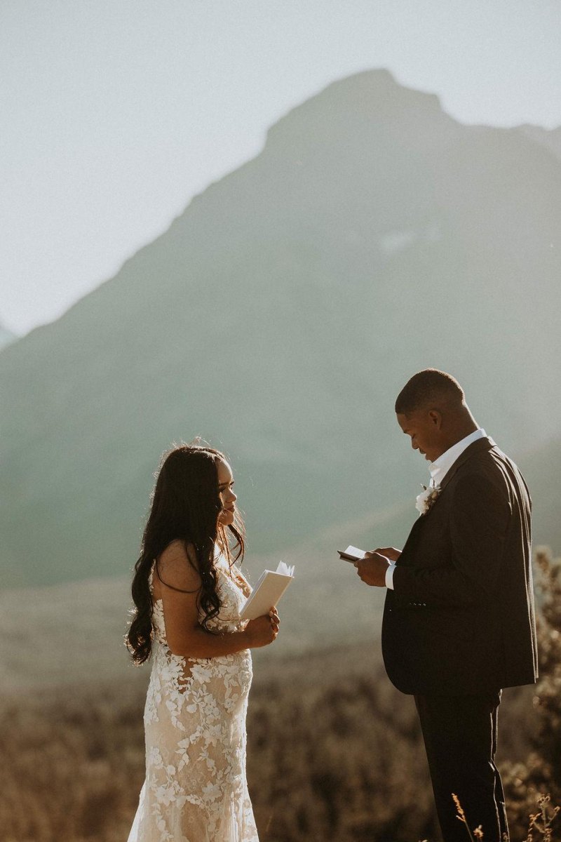 Couple exchanging vows outdoors elopement photography pose