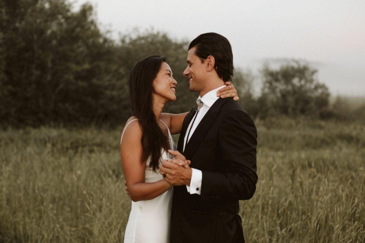 Wedding couple dancing in field elopement photography pose